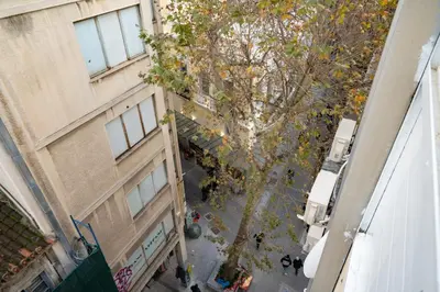 an overhead view of a tree between two buildings at Comfy Studio with private terrace by MPS in Athens