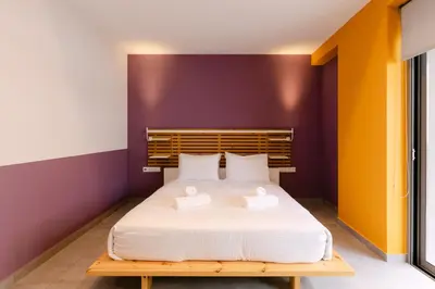 a bedroom with a bed with two towels on it at 11 Reasons Why Metaxourgeio in Athens