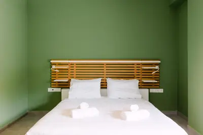 a bedroom with a bed with two white pillows at 11 Reasons Why Metaxourgeio in Athens