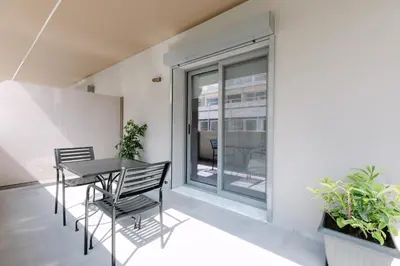 a dining room with a table and chairs and a window at 11 Reasons Why Metaxourgeio in Athens