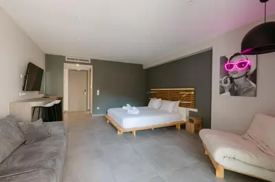 a bedroom with a bed with pink glasses on it at 11 Reasons Why Metaxourgeio in Athens
