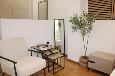 a living room with a chair and a table at ARIS- The Urban Retreat in Athens
