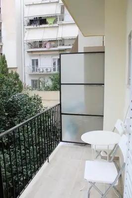 a balcony with a table and a building at ARIS- The Urban Retreat in Athens
