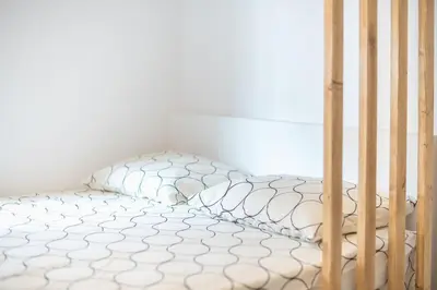 a bed in a room with a crib with a bedsheet at studio3 - -10-minutes-from-Monastiraki-Athens! in Athens