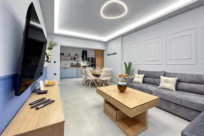 a living room with a couch and a table at Dione Elegant Apartment Near Acropolis in Athens