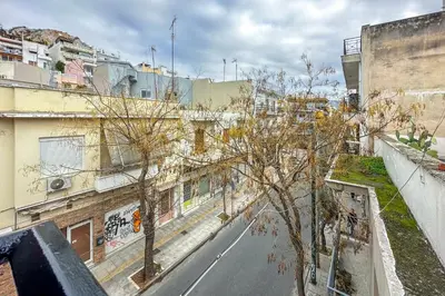 an empty street in a city with buildings at Dione Elegant Apartment Near Acropolis in Athens