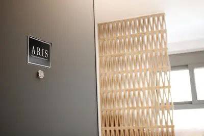 a door in a building with a sign on it at ARIS Petralona in Athens