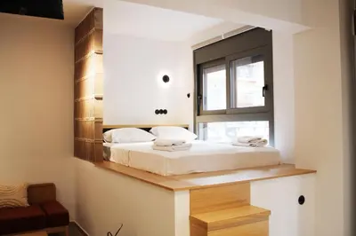 a bedroom with a bed with a mirror on the wall at ARIS Petralona in Athens