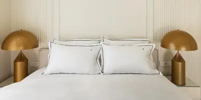 a white bed with white pillows and two lamps at 4bd Ensuite Luxury Residence Kolonaki in Athens