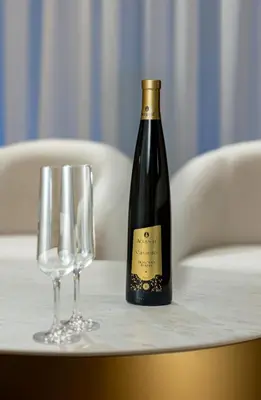 a bottle of wine and two glasses on a table at 4bd Ensuite Luxury Residence Kolonaki in Athens