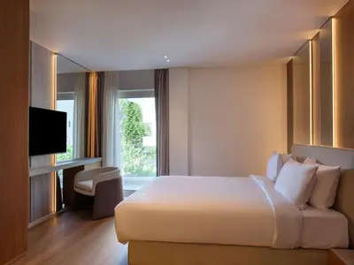 a hotel room with a bed and a television at Nur Riviera Aparthotel in Athens