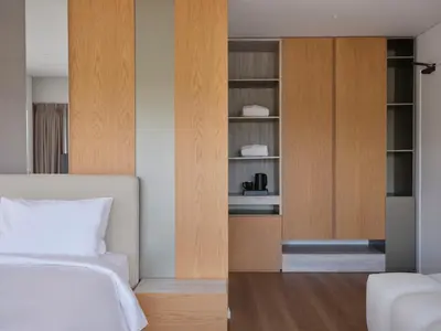 a bedroom with a bed and a cupboard at Nur Riviera Aparthotel in Athens