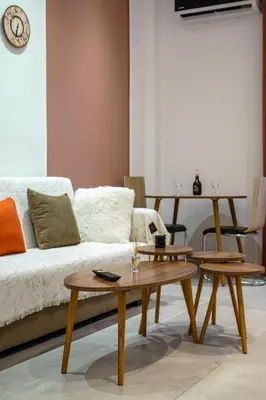 a living room with two tables and a couch at Acropolis Sneak peak 5th floor in Athens