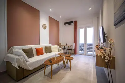 a living room with a couch and a table at Acropolis Sneak peak 5th floor in Athens