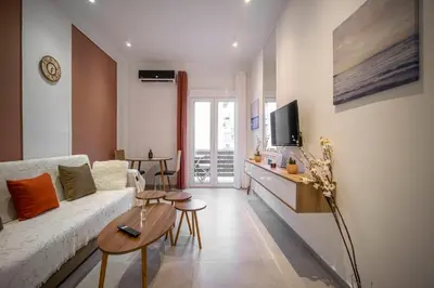 a living room with a couch and a table at Acropolis Sneak peak 5th floor in Athens