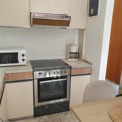 a kitchen with a stove and a microwave at Sagma Athens House Metro Panormou in Athens