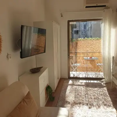 a living room with a couch and a flat screen tv at Sagma Athens House Metro Panormou in Athens