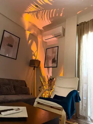 a living room with a couch and a chair at 22st Phoenix in Athens