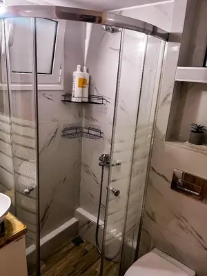 a shower with a glass door in a bathroom at 22st Phoenix in Athens