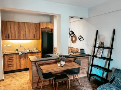 a kitchen with a table and chairs in a room at 22st Phoenix in Athens