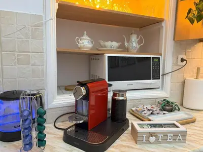 a kitchen with a coffee maker and a microwave at Neoclassical Royal Palace next to Acropolis in Athens