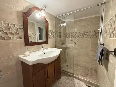 a bathroom with a sink and a shower at Neoclassical Royal Palace next to Acropolis in Athens