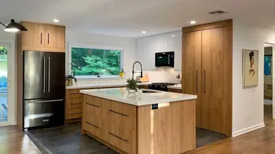 a kitchen with wooden cabinets and a stainless steel refrigerator at Island Private Apartment in Athens