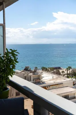 a view of the ocean from the balcony of a resort at Aelia-Smart central beach flat in Athens
