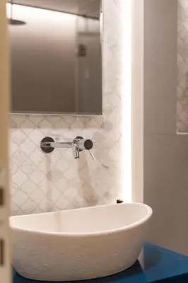 a white tub in a bathroom with a mirror at Aelia-Smart central beach flat in Athens