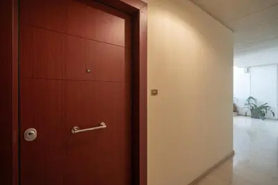 a wooden door with a handle in a hallway at Aelia-Smart central beach flat in Athens