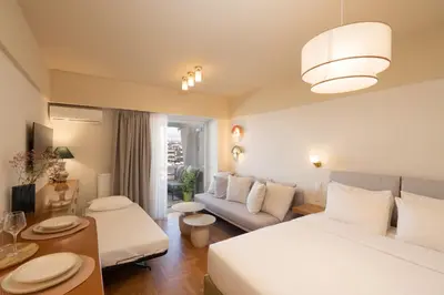 a hotel room with a bed and a couch at Aelia-Smart central beach flat in Athens