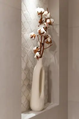 a white vase with flowers in it on a shelf at Aelia-Smart central beach flat in Athens