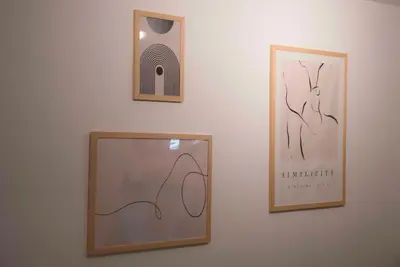 three framed pictures hanging on a white wall at Deluxe One in Athens