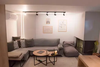 a living room with a couch and a table at Deluxe One in Athens