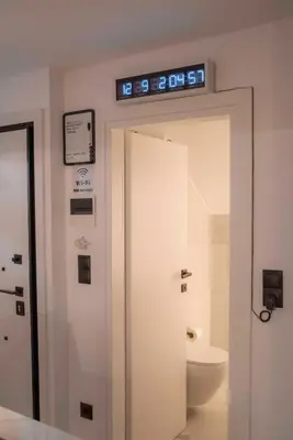 a bathroom with a toilet and a sign above a door at Deluxe One in Athens