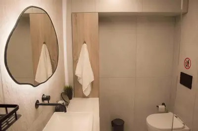 a bathroom with a sink and a mirror and a toilet at Deluxe One in Athens
