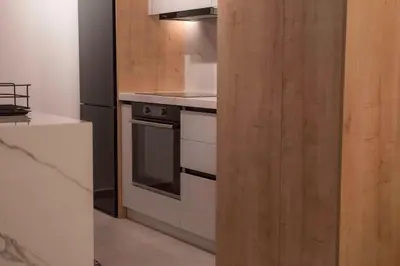 a kitchen with a stove and a refrigerator at Deluxe One in Athens