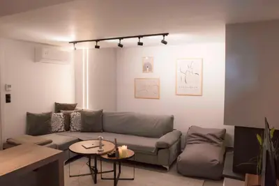 a living room with a couch and a table at Deluxe One in Athens
