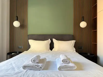 a bedroom with a bed with two towels on it at A27 High-Standing One-Bedroom Apartment in Athens