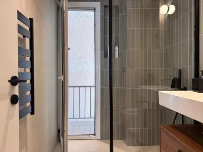 a bathroom with a glass shower and a sink at A27 High-Standing One-Bedroom Apartment in Athens