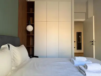a bedroom with a white bed with towels on it at A27 High-Standing One-Bedroom Apartment in Athens