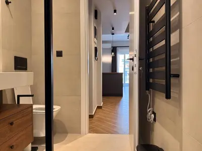 a bathroom with a toilet and a door to a hallway at A27 High-Standing One-Bedroom Apartment in Athens