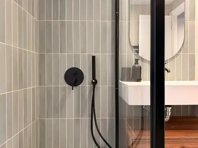a shower with a black shower head in a bathroom at A27 High-Standing One-Bedroom Apartment in Athens