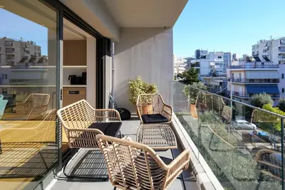 a balcony with wicker chairs and a view of a city at Luxurious Athens Residence in Athens