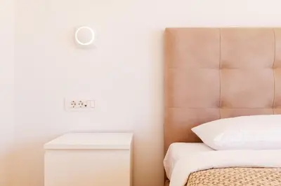 a bedroom with a bed and a clock on the wall at Luxurious Athens Residence in Athens