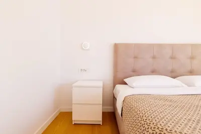 a bedroom with a bed and a white night stand at Luxurious Athens Residence in Athens