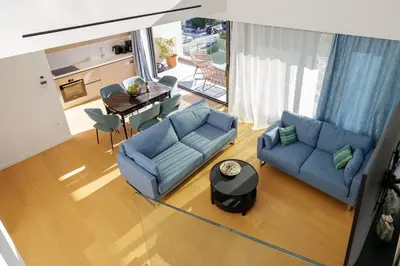 a living room with two blue couches and a table at Luxurious Athens Residence in Athens