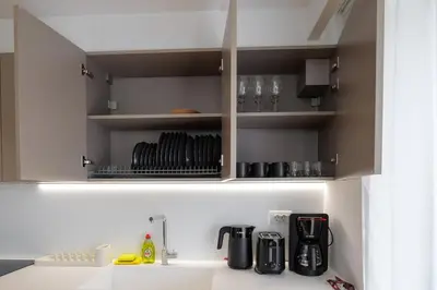 a kitchen with a cupboard with utensils at Luxurious Athens Residence in Athens