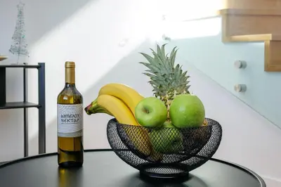 a bottle of wine and a bowl of fruit on a table at Luxurious Athens Residence in Athens