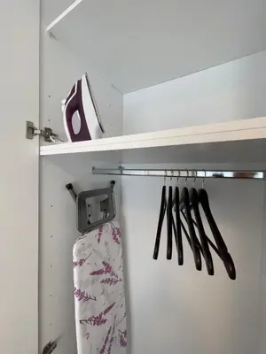 a closet with utensils hanging on a shelf at Cultural Retreat Near Stavros Niarchos Center in Athens